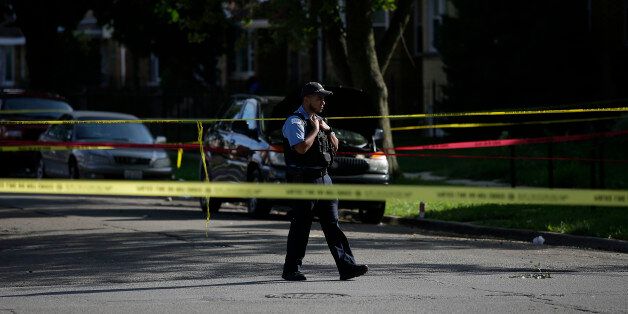 CHICAGO, IL - AUGUST 31: A Chicago police officer stands at the crime scene of a fatal shooting where a man was shot in the head in the 7300 block of South Rockwell Street on August 31, 2016 in Chicago, Illinois. Chicago has seen over 80 people killed and over 400 people shot and wounded during the month of August, making it the most violent month in 20 years. (Photo by Joshua Lott/Getty Images)