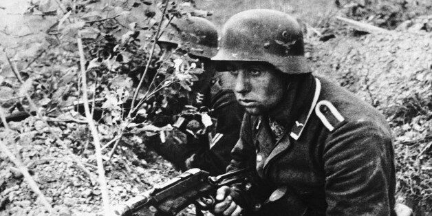 Determination and defeat are both expressed in the face of this Nazi trooper as he crouches low in a slit-trench, somewhere in Russia, on Jan. 5, 1944, waiting for the next Red army attack. (AP Photo)
