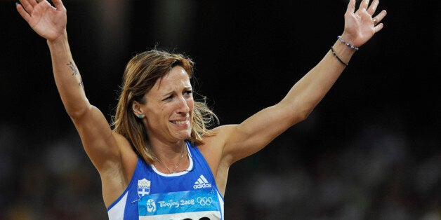 Hrysopiyi Devetzi of Greece reacts whilst competing in the women's triple jump final of the athletics competition in the National Stadium at the Beijing 2008 Olympic Games August 17, 2008. REUTERS/Kai Pfaffenbach (CHINA)