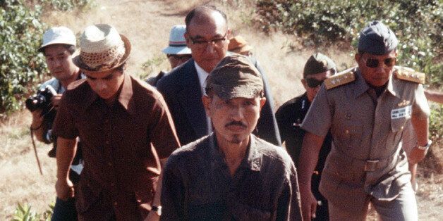 This picture taken on March 11, 1974 shows former Japanese imperial army soldier Hiroo Onoda (C) walking from the jungle where he had hidden since World War II, on Lubang island in the Philippines. Onoda, who hid in the Philippine jungle for three decades because he did not believe World War II was over, has died in Tokyo on January 17, 2014, at the age of 91. The former soldier waged a guerilla campaign in Lubang Island near Luzon until he was finally persuaded in 1974 that peace had broken out. JAPAN OUT AFP PHOTO / JIJI PRESS (Photo credit should read JIJI PRESS/AFP/Getty Images)