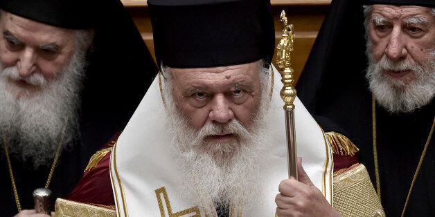 Leader of the Greek church Archbishop Ieronimos (C) attends the swearing-in ceremony of newly elected President Prokopis Pavlopoulos (not pictured) at the parliament in Athens March 13, 2015. REUTERS/Aris Messinis/Pool (GREECE - Tags: POLITICS RELIGION)