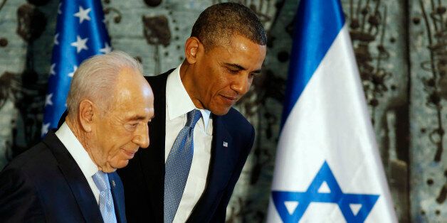 U.S. President Barack Obama (R) walks off stage together with Israel's President Shimon Peres after signing a guest book in Jerusalem, March 20, 2013. Making his first official visit to Israel, Obama pledged on Wednesday unwavering commitment to the security of the Jewish State where concern over a nuclear-armed Iran has clouded bilateral relations. REUTERS/Larry Downing (JERUSALEM - Tags: POLITICS)