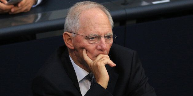 Wolfgang Schaeuble, Germany's finance minister, looks on as German Chancellor Angela Merkel speaks in the lower-house of the German Parliament in Berlin, Germany, on Wednesday, Sept. 7, 2016. Merkel said her government has done everything it can to reduce the influx of refugees as she defended her policy in the face of political criticism and voter discontent. Photographer: Krisztian Bocsi/Bloomberg via Getty Images