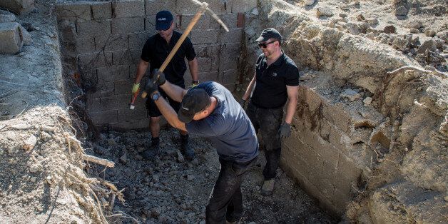 KOS, GREECE - SEPTEMBER 30: South Yorkshire Police work to excavate a sceptic tank in search of missing toddler Ben Needham on September 30, 2016 in Kos, Greece. The 21 month old toddler from Sheffield vanished on the Greek island in July of 1991. A 19-strong team of police officers, forensic specialists and an archaeologist have been searching an olive grove next to the farm house where the child was last seen playing however excavation on parts of the site halted today after the landowner com