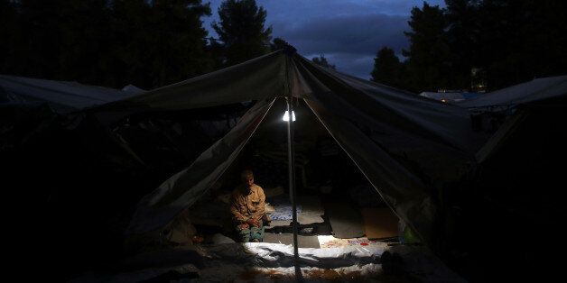 A Syrian man sits inside his tents at Ritsona refugee camp north of Athens, which hosts about 600 refugees and migrants on Thursday, Sept. 22, 2016. Most of the roughly 60,000 refugees and other migrants stranded in Greece are living in