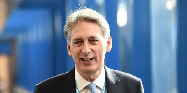 British Chancellor of the Exchequer Philip Hammond walks along the bridge from the hotel to the International Convention Centre in Birmingham, central England, on October 2, 2016 on the first day of the Conservative party annual conference.Britain's governing Conservative Party meets for its annual conference from Sunday facing questions over how and when it will take the country out of the European Union following the Brexit vote. / AFP / OLI SCARFF (Photo credit should read OLI SCARFF/AFP/Getty Images)