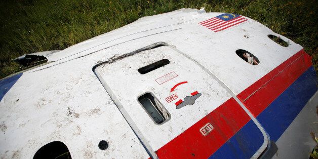 A piece of the wreckage is seen at a crash site of the Malaysia Airlines Flight MH17 near the village of Petropavlivka (Petropavlovka), Donetsk region July 24, 2014. The Dutch are due to announce on Wednesday 28 September the long-awaited results of an investigation with Australia, Malaysia, Belgium and Ukraine into the July 17, 2014 downing of the flight. REUTERS/Maxim Zmeyev/File Photo FROM THE FILES PACKAGE - SEARCH