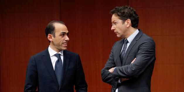 Cyprus' Finance Minister Harris Georgiades listens to Dutch Finance Minister and Eurogroup chairman Jeroen Dijsselbloem (R) during an eurozone finance ministers meeting at the EU Council in Brussels January 27, 2014. REUTERS/Francois Lenoir (BELGIUM - Tags: POLITICS BUSINESS)