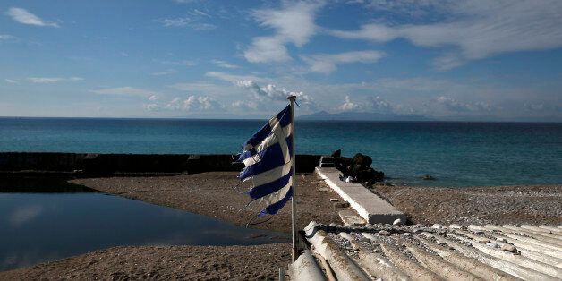 A frayed Greek national flag flutters on a morning at a beach in the southern suburb of Alimos, near Athens March 1, 2015. German Finance Minister Wolfgang Schaeuble told a German newspaper he was sure the Greek government would be able to fulfil the conditions attached to its bailout but warned that it would receive no further aid if it did not keep its promises. REUTERS/Alkis Konstantinidis (GREECE - Tags: POLITICS BUSINESS SOCIETY)