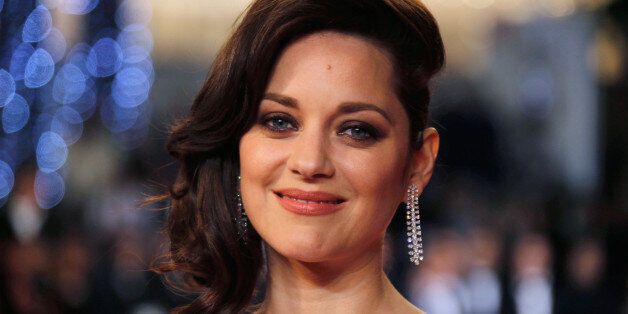 FILE PHOTO -- Cast member Marion Cotillard poses on the red carpet as they arrive for the screening of the film