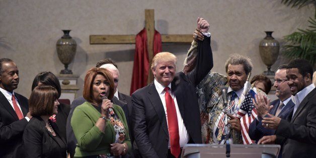 Boxing promoter Don King (2nd R) raises the arm of Republican presidential nominee Donald Trump (C) during the Midwest Vision and Values Pastors and Leadership Conference at the New Spirit Revival Center in Cleveland Heights, Ohio on September 21, 2016. / AFP / MANDEL NGAN (Photo credit should read MANDEL NGAN/AFP/Getty Images)