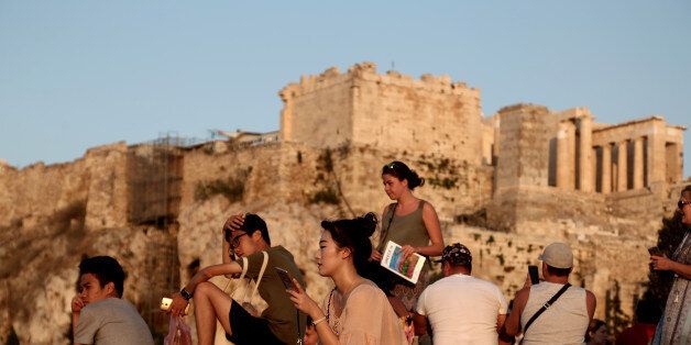 Tourists at the Athens Acropolis on 26 July 2016.Andreadis president of SETE (Association of Greek Tourism Enterprises) Greece might win 'last minute' tourists planning to go to Turkey, but ultimately because of the situation after the coup choose Greece, however, the overall tourism development remains fragile. Earlier this year, SETE had predicted a 5% increase in tourism revenue for 2016 to 15 billion Euros and 25 million tourists (23.6 mil. Last year). (Photo by Panayiotis Tzamaros/NurPhoto via Getty Images)