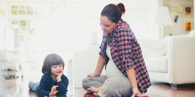 Small boy with his mother using a digital tablet