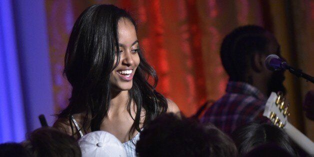 Malia Obama, daughter of US President Barack Obama, makes her way off the stage after her father sang 'Happy Birthday' for her during an Independence Day Celebration for military members and administration staff on July 4, 2016 in the East Room of the White House in Washington, DC. / AFP / Mandel Ngan (Photo credit should read MANDEL NGAN/AFP/Getty Images)