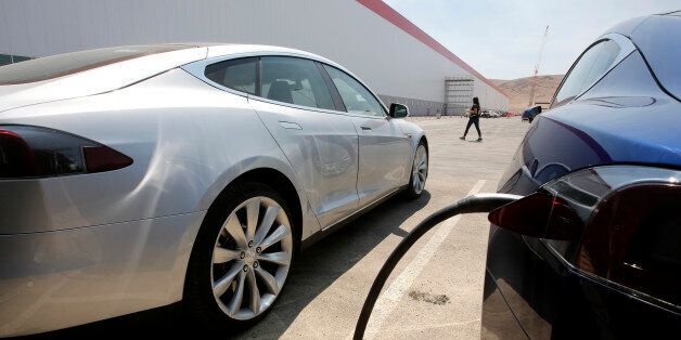 Tesla Motors model S cars are charged at the new Tesla Gigafactory, Tuesday, July 26, 2016, in Sparks, Nev. The Gigafactory is Tesla Motorsâ biggest bet yet: A massive, $5 billion factory in the Nevada desert that could almost double the worldâs production of lithium-ion batteries by 2018. (AP Photo/Rich Pedroncelli)
