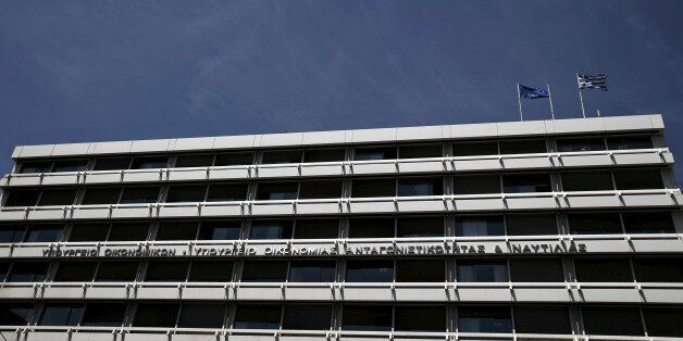 A European Union (L) and a Greek national flag flutter atop the Greek Finance Ministry in Athens May 6, 2015. The European Central Bank's Governing Council on Wednesday may nudge up the amount of Emergency Liquidity Assistance teetering Greek banks can borrow, as Athens struggles to avert a potentially catastrophic funding crunch. REUTERS/Alkis Konstantinidis