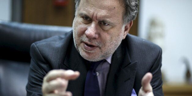 Greek Labour Minister George Katrougalos gestures during an interview with Reuters at his office at the ministry in Athens, Greece, February 24, 2016. Greece's left-led government will not cut pensions again even if its international lenders demand it, the country's labour minister told Reuters on Thursday, saying the income of the weak will be protected. REUTERS/Alkis Konstantinidis