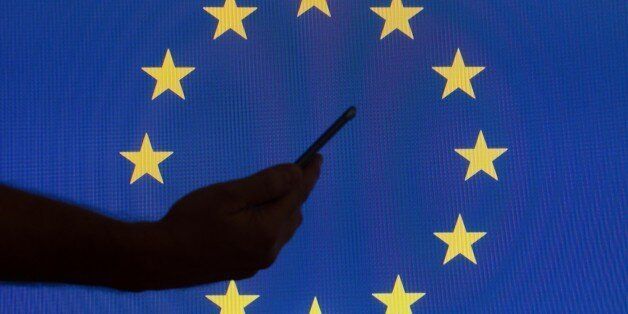 The EU flag is seen with logos of American technology companies. (Photo by Jaap Arriens/NurPhoto via Getty Images)