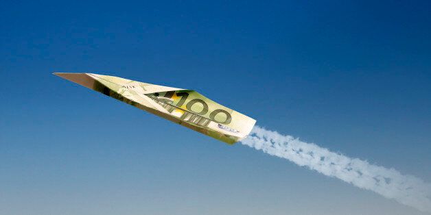 Airplane made of 100 EURO against blue sky