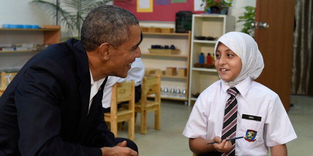 President Barack Obama, left, meets with children as he tours the Dignity for Children Foundation in Kuala Lumpur, Malaysia, Saturday, Nov. 21, 2015. He is visiting this center in Malaysia that helps lower income families including refugees, casting a spotlight on the plight of those fleeing violence and persecution from Myanmar to Syria. (AP Photo/Susan Walsh)