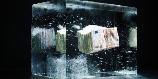 50 EUR money bundle being frozen in an ice block.