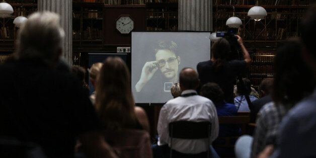 National Security Agency leaker Edward Snowden speaks via video link during the Athens Democracy Forum, organised by the New York Times, at the National Library in Athens, Friday, Sept. 16, 2016. Snowden, in exile in Moscow after leaking U.S. National Security Agency documents, said Friday he intends to vote in the U.S. presidential election, but did not say which candidate he favors. (Kostas Baltas, InTime Sports via AP)