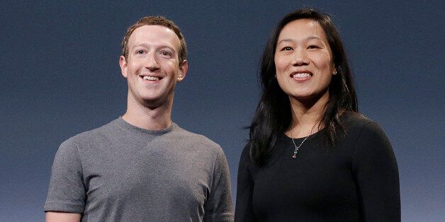 In this Tuesday, Sept. 20, 2016, photo, Facebook CEO Mark Zuckerberg and his wife, Priscilla Chan, smile as they prepare for a speech in San Francisco. Zuckerberg and Chan have a new lofty goal: to cure, manage or eradicate all disease by the end of this century. To this end, the Chan Zuckerberg Initiative, the couple's philanthropic organization, is committing significant financial resources over the next decade to help accelerate basic science research. (AP Photo/Jeff Chiu)
