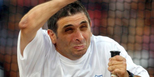 Greece's Pantelis Kalogeros attempts during the Men's discus F32/51 finals at the Beijing 2008 Paralympic Games held in Beijing, China, Thursday, Sept. 11, 2008. (AP Photo/Ng Han Guan)