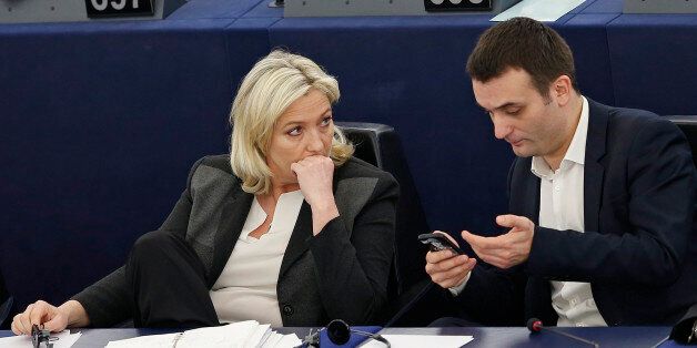 France's far-right National Front political party leader and member of the European Parliament Marine Le Pen (L) speaks with fellow MEP and party member Florian Philippot, ahead of a voting session at the European Parliament in Strasbourg, March 11, 2015. Le Pen said on Tuesday she would file a complaint against the European Parliament President Martin Schulz alleging he made false allegations against her National Front party in alerting the EU fraud squad to possible funding abuses. REUTERS/Vincent Kessler (FRANCE - Tags: POLITICS)