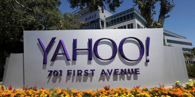Flowers bloom in front of a Yahoo sign at the company's headquarters Tuesday, July 19, 2016, in Sunnyvale, Calif. (AP Photo/Marcio Jose Sanchez)