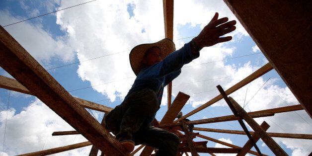 A Colombian from the Revolutionary Armed Forces of Colombia (FARC) works on a platform to prepare accommodation for an upcoming congress ratifying a peace deal with the government, near El Diamante in Yari Plains, Colombia, September 9, 2016. Picture taken September 9, 2016. REUTERS/John Vizcaino