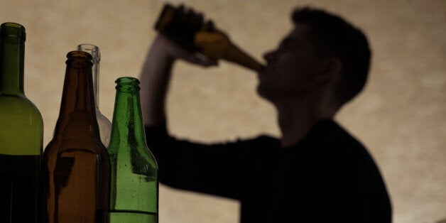 Alcoholism among young people - teenager drinking beer