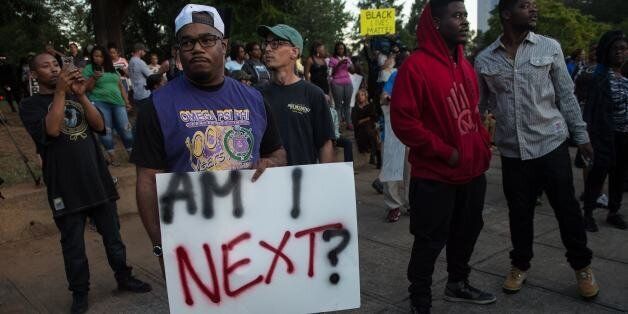 Protesters attend a demonstration against police brutality in Charlotte, North Carolina, on September 21, 2016, following the shooting of Keith Lamont Scott the previous day.A protester shot during a second night of unrest in Charlotte, North Carolina was critically wounded, the city said, after earlier reporting that the person had died. / AFP / NICHOLAS KAMM (Photo credit should read NICHOLAS KAMM/AFP/Getty Images)