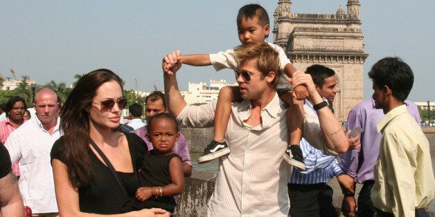 **FILE** Actress and UNHCR Ambassador Angelina Jolie, left, with daughter Zahara, and Brad Pitt, second right, with son Maddox, walk near the Gateway of India, in background, in Mumbai, India, in this Nov. 12, 2006 file photo. The megastars were spotted Friday, Aug. 24, 2007 with kids Maddox, Zahara and Pax shopping at Lee's Art Shop on West 57th Street. Baby Shiloh was not there. (AP Photo)