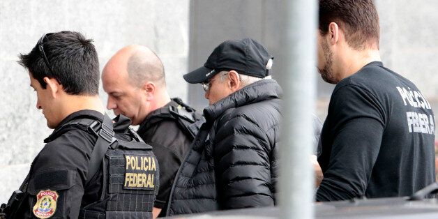 Former Brazilian Economy Minister Guido Mantega (2-R) is escorted by Federal Police agents, after being arrested in Sao Paulo, Brazil on September 22, 2016.Brazilian police Thursday arrested Guido Mantega, a former finance minister under presidents Lula da Silva and Dilma Rousseff, as part of the investigation into the vast Petrobras corruption scheme, media reported. Mantega, who was an important figure in the leftist Workers' Party, was arrested at a Sao Paulo hospital where his wife had undergone surgery. / AFP / Miguel Schincariol (Photo credit should read MIGUEL SCHINCARIOL/AFP/Getty Images)
