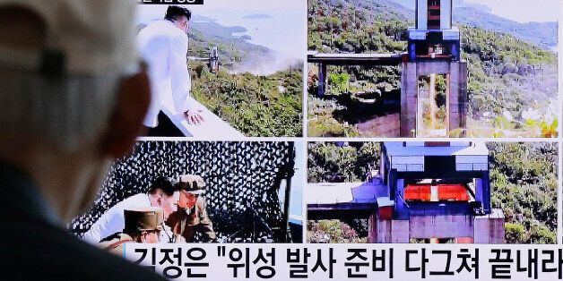 A man watches a TV news showing images that North Korea's Rodong Sinmun newspaper reports of the ground test of a high-powered engine of a carrier rocket and North Korean leader Kim Jong Un at the country's Sohae Space Center, at Seoul Railway station in Seoul, South Korea, Tuesday, Sept. 20, 2016. North Korean leader Kim has overseen a ground test of a new rocket engine and ordered a satellite launch preparation, state media said Tuesday, an indication the country might soon conduct a prohibited long-range rocket launch. The letters read