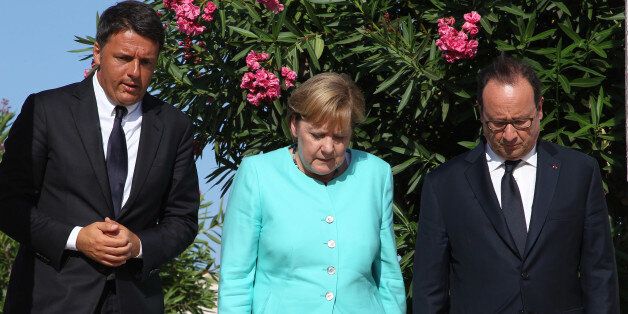 Italian Premier Matteo Renzi, left, German Chancellor Angela Merkel, center, and French President Francois Holland pay their homage at the tomb of Altiero Spinelli, one of the founding fathers of European unity, in the cemetery of the island of Ventotene, Italy, Monday, Aug. 22, 2016. Standing silently together, the three leaders placed three bouquets of blue and yellow flowers, the colors of the European Union, on the simple white marble tombstone of Altiero Spinelli in the cemetery of the island of Ventotene. (Carlo Hermann/Pool Photo via AP)