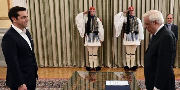 Greece's leftwing Syriza leader and newly elected Greek Prime Minister Alexis Tsipras (L) attends the oath-taking ceremony with Greece's President Prokopis Pavlopoulos in Athens, on September 21, 2015, a day after the Greek general election. Syriza won 35.5 percent of the vote against 28 percent for conservative New Democracy and is likely to again form a coalition government with the nationalist Independent Greeks (ANEL) party. The EU congratulated Tsipras on his left-wing party's re-election v