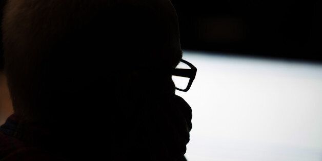 Man in glasses looking at a screen