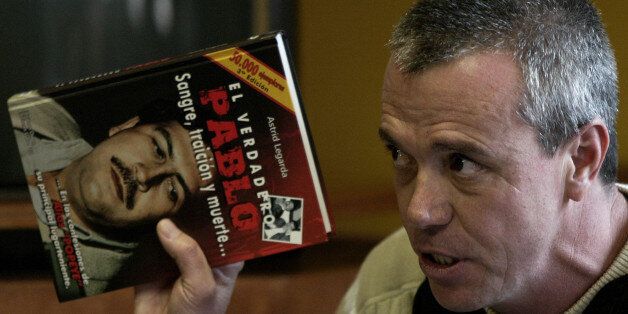 FILE - In this June 27, 2006, file photo, John Jairo Velasquez, a former hit man for Pablo Escobar, gives his testimony while holding a book titled
