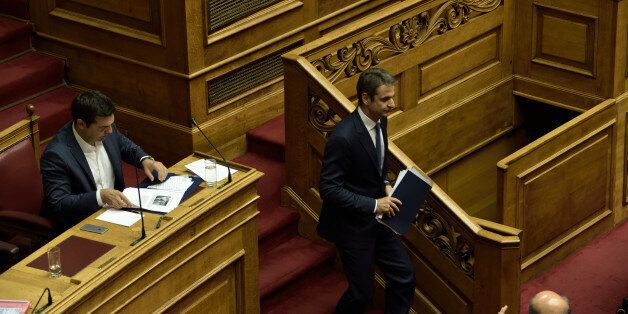 HELLENIC PARLIAMENT, ATHENS, ATTIKI, GREECE - 2016/07/21: Leader of New Democracy and leader of the opposition, Kyriakos Mitsotakis (right) is passing by Greek Prime Minister Alexis Tsipras (left), at the end of his speech in Hellenic Parliament. (Photo by Dimitrios Karvountzis/Pacific Press/LightRocket via Getty Images)