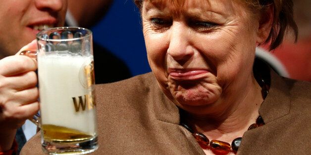 German Chancellor Angela Merkel drinks a beer during Christain Democratic Union (CDU) political Ash Wednesday meeting in Volkmarsen, Germany February 29, 2016. REUTERS/Kai Pfaffenbach