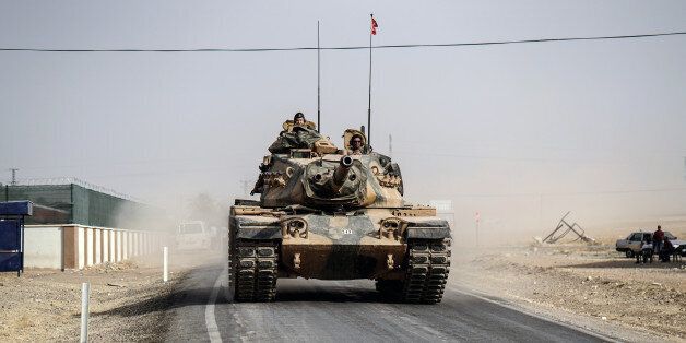 Turkish army tanks and armored personnel carriers move toward the Syrian border, in Karkamis, Turkey, Thursday, Aug. 25, 2016. Turkish President Recep Tayyip Erdogan late Wednesday said that Syrian opposition forces aided by Ankara have taken back the border town of Jarablus from the Islamic State group. Erdogan said the Syrian rebels,