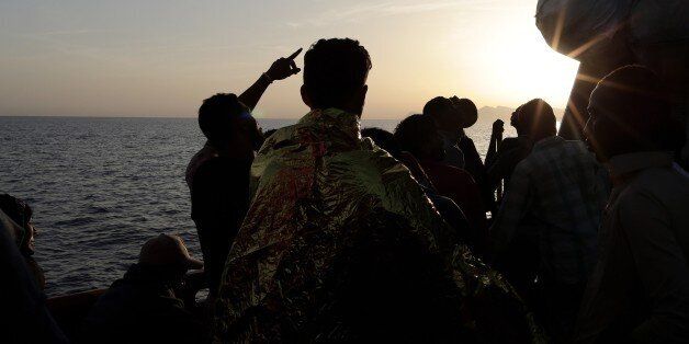 Rescued migrants stand aboard the rescue vessel Responder, run by the Malta-based NGO Migrant Offshore Aid Station (MOAS) and the Italian Red Cross, Saturday, Aug. 20, 2016. The U.N. refugee agency says that survivors of a shipwreck off Libya have reported at least seven people, including three children, died when the small wooden boat carrying 27 people, mostly Syrian refugees, capsized. UNHCR representative Medea Savary said that survivors arriving in the Sicilian port of Trapani on Saturday reported that a woman and another child also died, but that the bodies couldnât be recovered. (Yara Nardi/Italian Red Cross via AP)