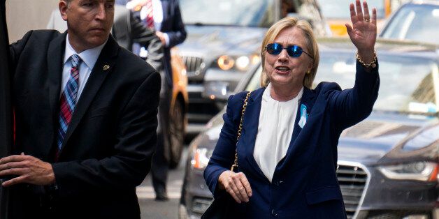 Democratic presidential candidate Hillary Clinton walks from her daughter's apartment building Sunday, Sept. 11, 2016, in New York. Clinton unexpectedly left Sunday's 9/11 anniversary ceremony in New York after feeling