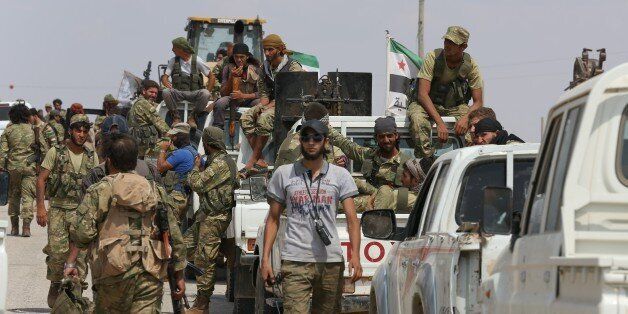 JARABLUS, SYRIA - SEPTEMBER 03 : Soldiers belonging to Free Syrian Army are seen as they are on their way to Al-Rai village during Operation Euphrates Shield in Jarablus, Syria on September 03, 2016. The anti-Daesh operation, called Euphrates Shield, is aimed at clearing terrorist groups from the Turkish border region, tightening border security, and supporting Syrias territorial integrity. (Photo by Cem Ozdel/Anadolu Agency/Getty Images)