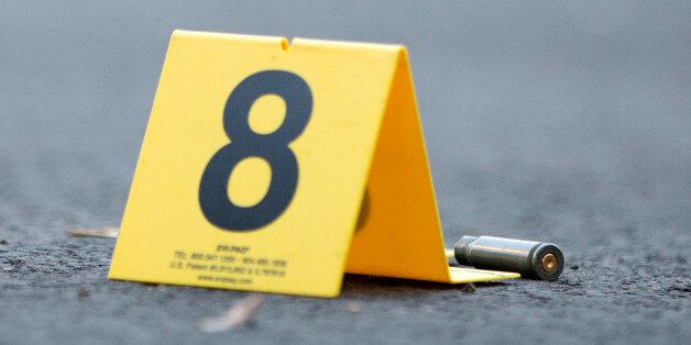 An evidence marker sits next to a rifle casing at the scene of a fatal shooting in the 4500 block of South Hermitage Avenue Monday, Labor Day, Sept. 5, 2016, in the Back of the Yards neighborhood of Chicago. A 44-year-old man was shot in killed. (Erin Hooley/Chicago Tribune/TNS via Getty Images)