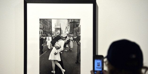 A visitor takes a snapshot of 'VJ Day a Times Square, New York, NY, 1945' by Alfred Eisenstaedt during the 'Life. I grandi fotografi' (Life. The great photographers) exhibition at the auditorium on April 30, 2013 in Rome. The exhibition showing some 150 pictures taken from 1936 when the US magazine Life magazine premiered will be open from May, 1 to August 4, 2013. AFP PHOTO / GABRIEL BOUYS RESTRICTED TO EDITORIAL USE, MANDATORY CREDIT OF THE ARTIST, TO ILLUSTRATE THE EVENT AS SPECIFIED IN THE CAPTION (Photo credit should read GABRIEL BOUYS/AFP/Getty Images)