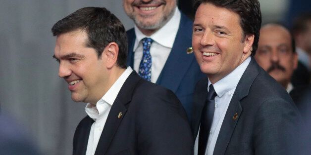 Italian Premier Matteo Renzi, right, shares a laugh with Greek Premier Alexis Tsipras before the first working session of the North Atlantic Council at the NATO summit in Warsaw, Poland, Friday, July 8, 2016. Starting Friday, US President Barack Obama and leaders of the 27 other NATO countries will take decisions in Warsaw on how to deal with a resurgent Russia, violent extremist organizations like Islamic State, attacks in cyberspace and other menaces to allies' security during a summit described by many observers as NATO's most crucial meeting since the 1989 fall of the Berlin Wall.(AP Photo/Markus Schreiber)