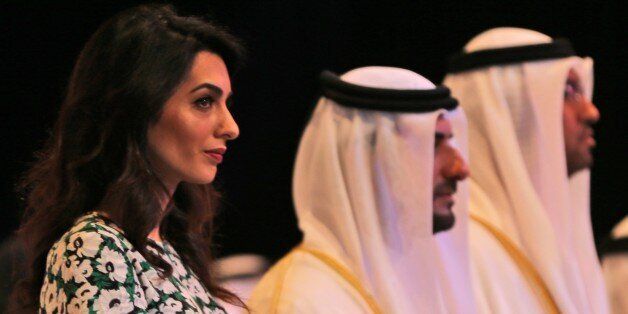 Amal Alamuddin Clooney, writer, human rights activist, 3rd left, listens to the national anthem during the opening ceremony of the International Government Communications Forum in Sharjah, United Arab Emirates. (AP Photo/Kamran Jebreili)